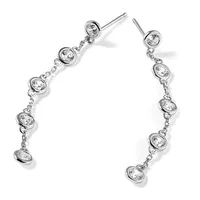 Pair of silver drop earrings with bezel-set round diamonds connected by delicate chains, displayed against a white background.