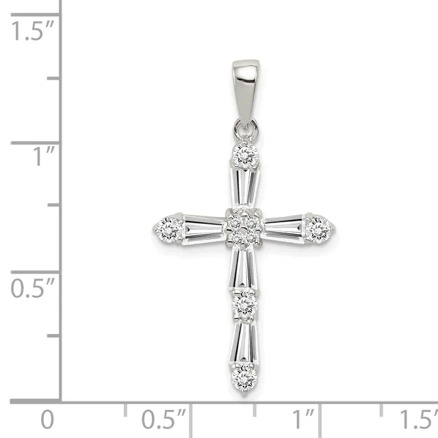 White gold cross pendant with round and baguette-cut diamonds arranged in a decorative pattern, shown against a measurement scale indicating approximately one inch in width.