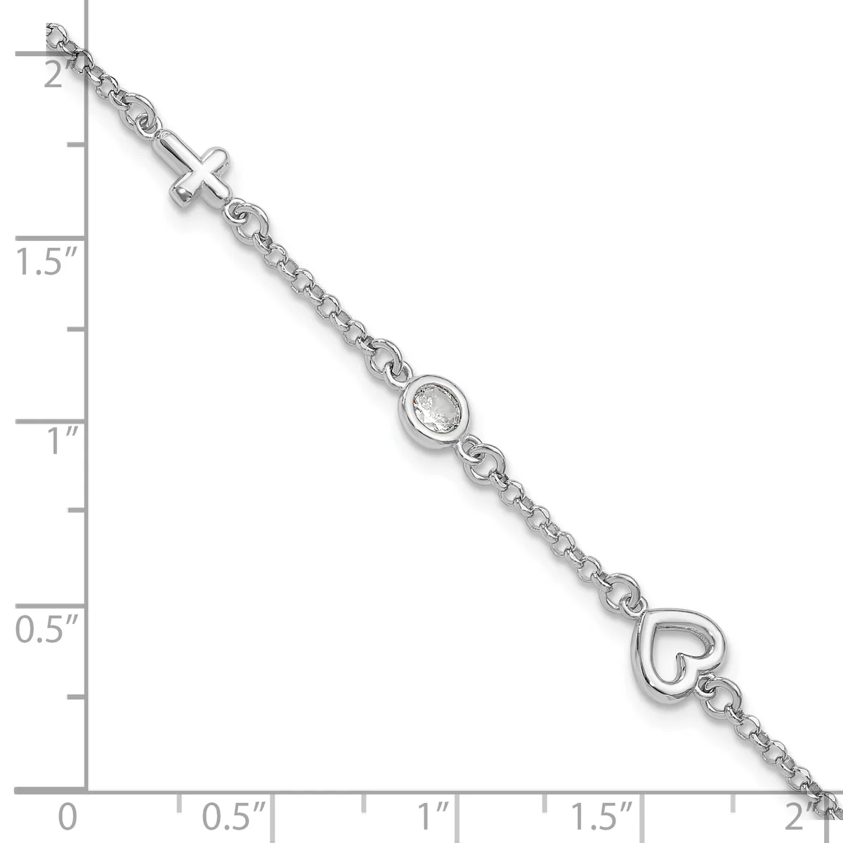 Silver bracelet with a cross charm, a cubic zirconia stone, and a heart charm, displayed against a measurement scale showing approximately two inches in length.