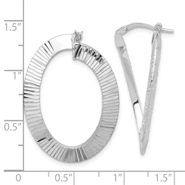 Pair of silver oval hoop earrings with ridged texture and post closures, shown next to a measurement scale indicating approximately 1.25 inches in length.