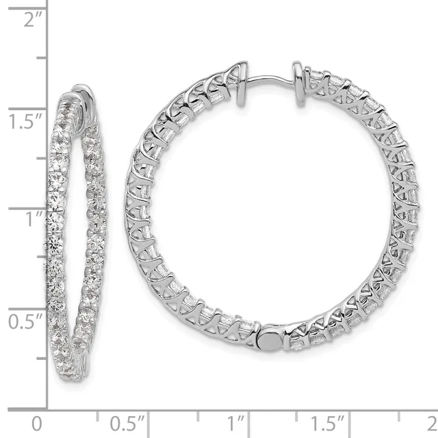 A pair of silver hoop earrings with diamond pavé setting shown from front and side views against a measurement scale.