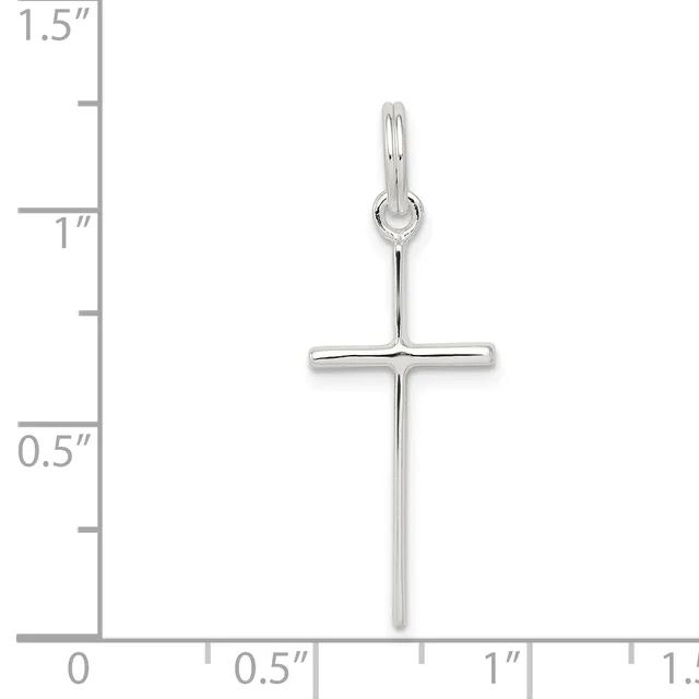 A silver cross pendant with a polished finish and small loop at the top, displayed against a ruler showing it measures approximately 1.25 inches in length.