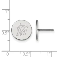 A circular silver stud earring with an engraved initial M and a matching post shown beside it, displayed against a measurement scale.