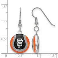 A pair of silver-tone earrings with orange and black enamel baseball-shaped charms, shown front and side view against a measurement scale.