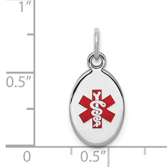 Small oval medical alert pendant in silver-tone metal with red enameled caduceus symbol, shown with measurement scale indicating approximately 0.5 inches wide by 1 inch tall.