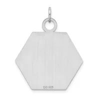A brushed silver hexagonal pendant with a small loop at the top and a small stamped hallmark on the lower portion.