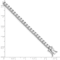 A silver tennis bracelet with square-cut cubic zirconia stones set in a line, displayed against a ruler showing its length of approximately 2.5 inches.