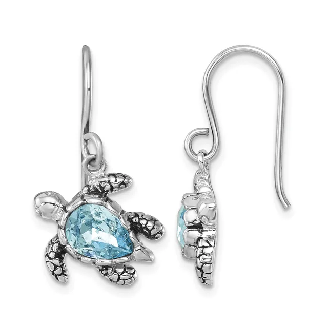 Pair of silver sea turtle earrings with light blue teardrop-shaped stones, shown from front and back views, hanging from curved ear wires.