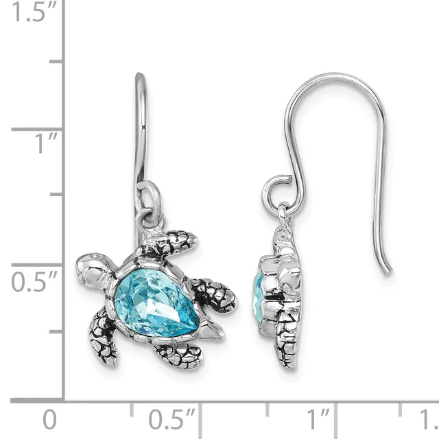 Pair of silver sea turtle earrings with blue topaz shells and textured fins, shown front and back against a measurement scale.