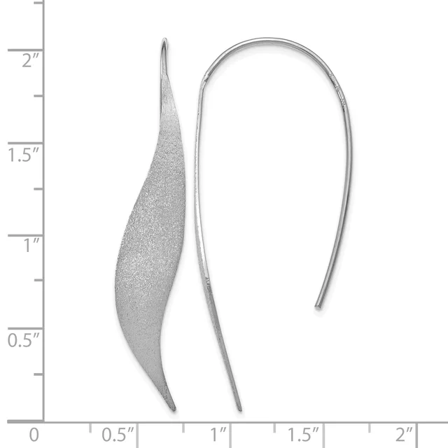 Two silver earrings shown against a ruler measuring up to two inches: one curved leaf-shaped earring with a textured surface, and one simple curved hook earring.