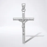 A silver crucifix pendant with a polished finish, featuring a detailed corpus figure, shown against a white background with a shadow visible to the right.