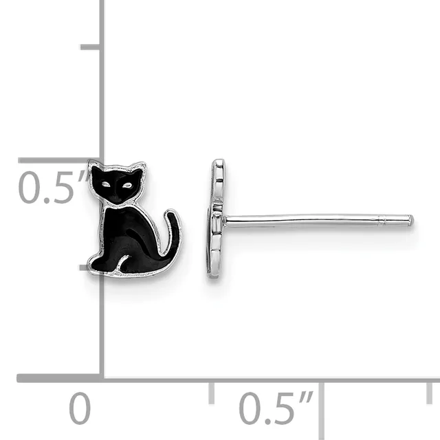A pair of black enamel cat stud earrings with white eye details shown next to a ruler for scale, measuring approximately 0.5 inches.