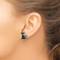 A person wearing a black cat-shaped stud earring in their earlobe, shown in profile with brown hair pulled back.
