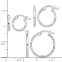 Three pairs of polished silver-toned hoop earrings in graduated sizes displayed on a measurement scale, ranging from approximately one inch to one and one-half inches in diameter.