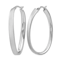 A pair of polished silver hoop earrings with a flat, wide oval shape and hinged closure posts, displayed against a white background.