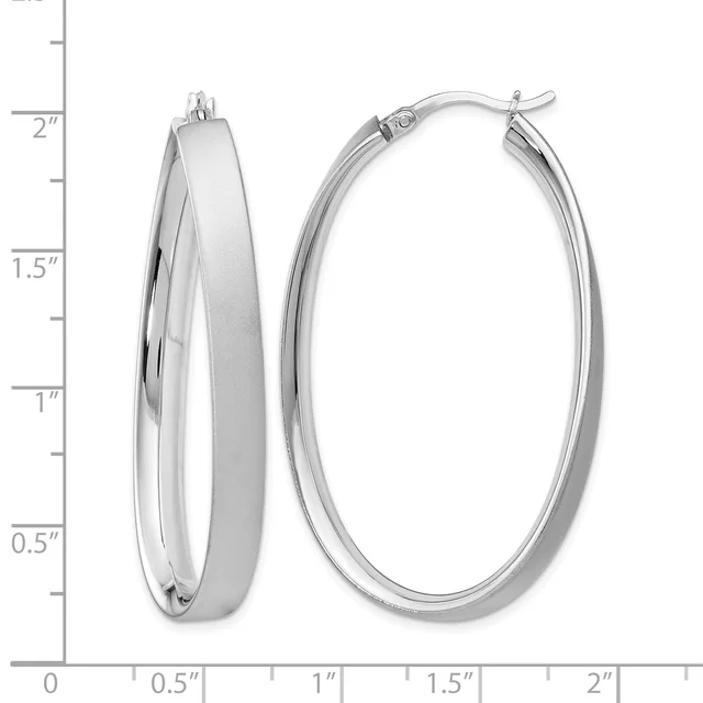 A pair of polished silver oval hoop earrings with hinged closures, displayed against a measurement scale showing approximately 2 inches in length.