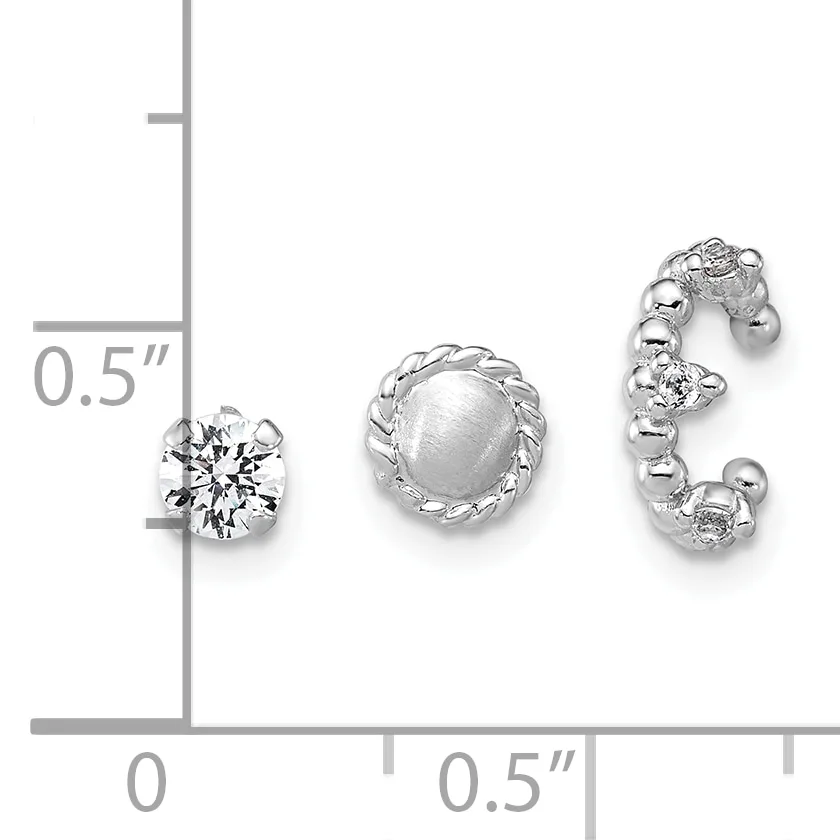 Three silver earrings displayed on a measurement scale: a round stud with a faceted clear stone, a round stud with a frosted dome, and a curved hoop with alternating clear and frosted spheres.