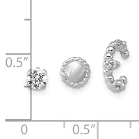Three silver earrings displayed on a measurement scale: a round stud with a faceted clear stone, a round stud with a frosted dome, and a curved hoop with alternating clear and frosted spheres.