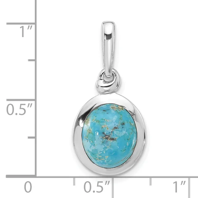 Silver pendant with oval turquoise stone set in bezel, shown against measurement scale indicating approximately one inch in height.