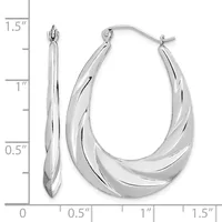 A pair of silver twisted hoop earrings with a measurement scale showing they are approximately 1.5 inches long.