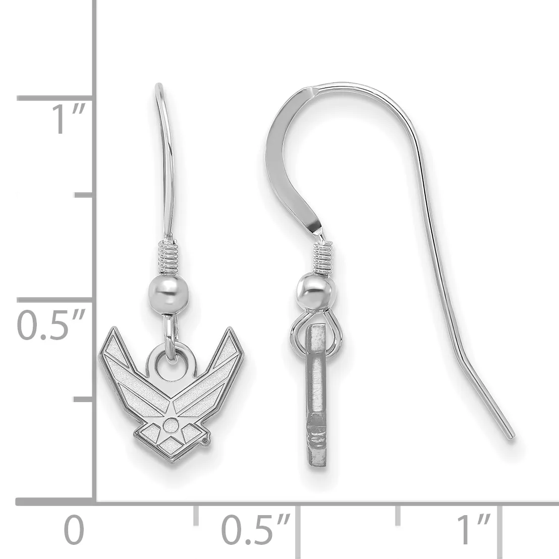A pair of silver-toned dangle earrings with fish hook wires, featuring small spheres and winged insignia charms, displayed against a measurement scale.
