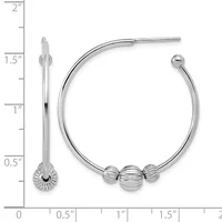 A pair of silver hoop earrings with three decorative ridged spheres, displayed next to a measurement scale showing the hoops are approximately one and one-half inches in diameter.