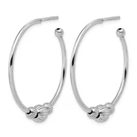 A pair of polished silver hoop earrings with textured ball details at the bottom and post closures at the top.