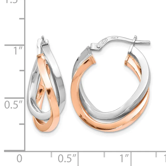 Two-tone hoop earrings with interlocking silver and rose gold curved bands, displayed next to a measurement ruler showing approximately one inch in diameter.