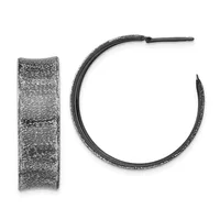 Pair of textured silver hoop earrings shown from the front and side, displaying a brushed finish with linear surface patterns.