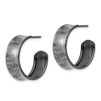 A pair of textured silver hoop earrings with a brushed finish and dark inner surfaces, displayed against a white background.