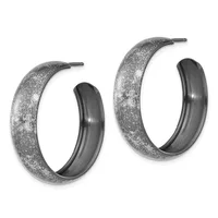 A pair of textured silver hoop earrings with a sparkly finish and polished inner surface, displayed side by side.