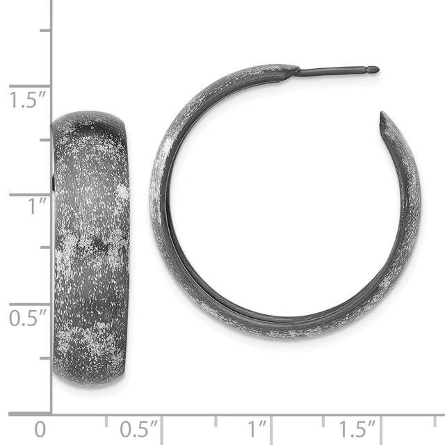 Two textured silver-toned hoop earrings displayed next to a ruler showing dimensions of approximately 1 inch diameter and 0.5 inch width.