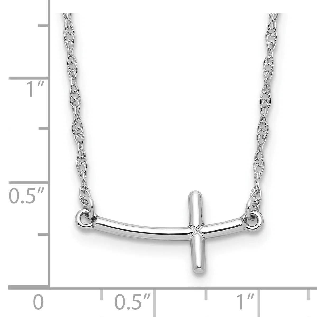 Silver cross pendant necklace with curved bar design, shown against a ruler measuring approximately one inch in length and width.
