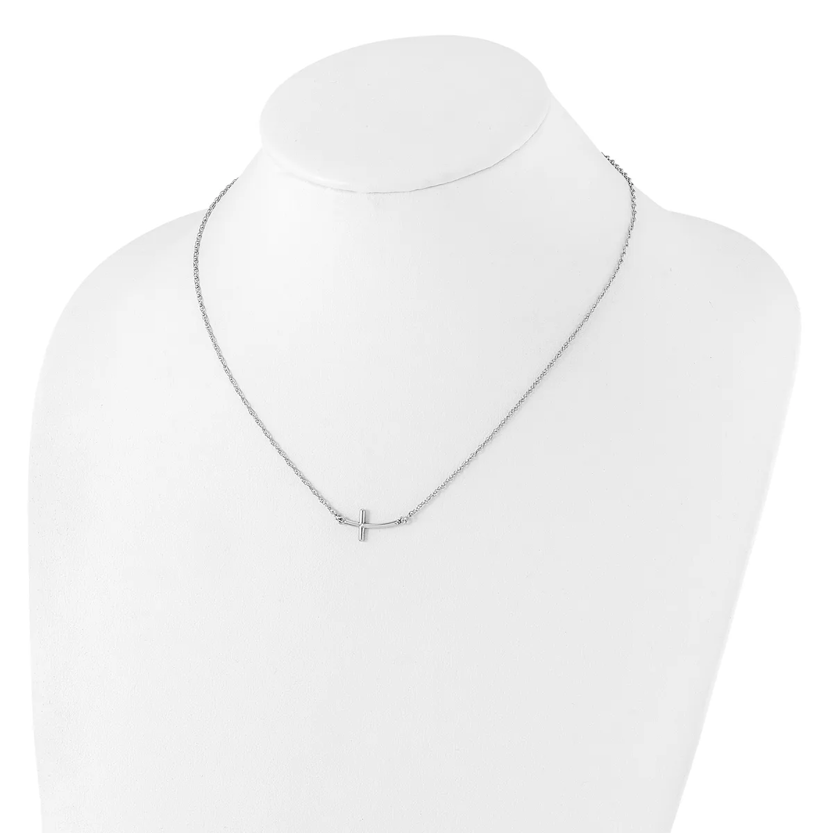 Silver-toned delicate chain necklace with a small cross pendant, displayed on a white mannequin bust.