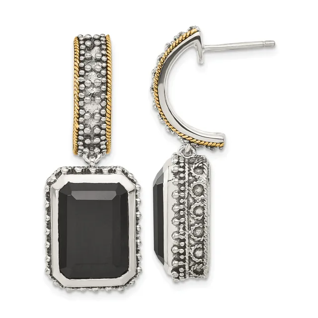 A pair of two-tone dangle earrings featuring rectangular black onyx stones surrounded by textured metalwork with twisted gold-tone trim on the upper hoops.