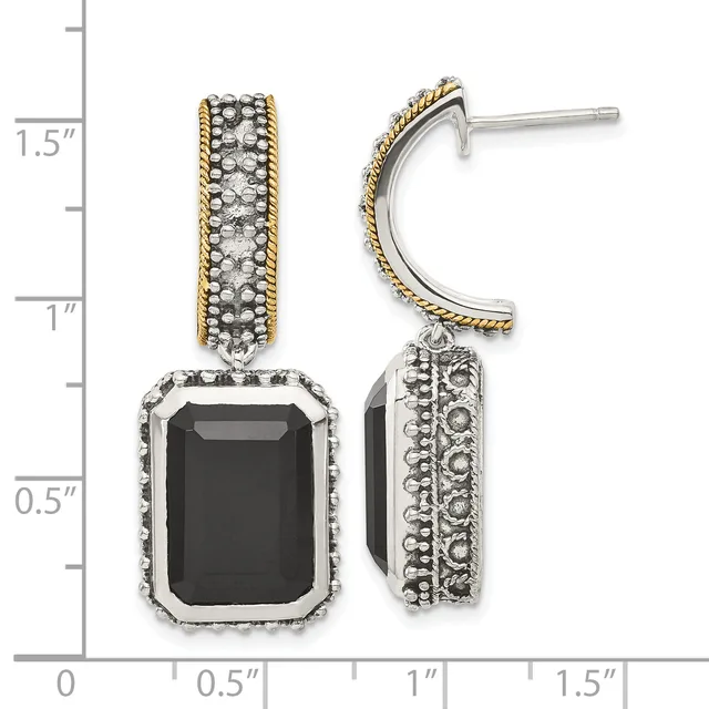 Two-tone dangle earrings featuring black onyx rectangles surrounded by beaded silver frames with twisted gold accent bands, shown on a measurement scale.