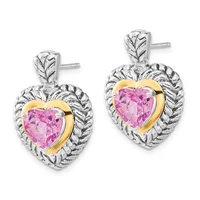 A pair of heart-shaped earrings featuring pink gemstones in gold bezels surrounded by textured silver rope-style frames with stud posts.