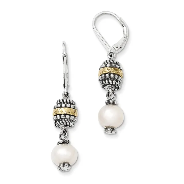 Pair of silver dangle earrings with ornate beaded caps in two-tone silver and gold, each suspending a white pearl, shown on white background.