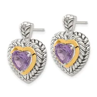 Pair of silver and gold heart-shaped earrings with purple amethyst centers and textured leaf detailing, shown on posts.