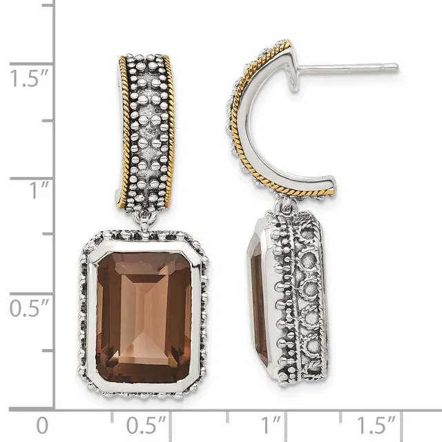 Two-tone silver and gold dangle earrings with smoky quartz rectangular stones surrounded by beaded frames, displayed against a measurement scale.