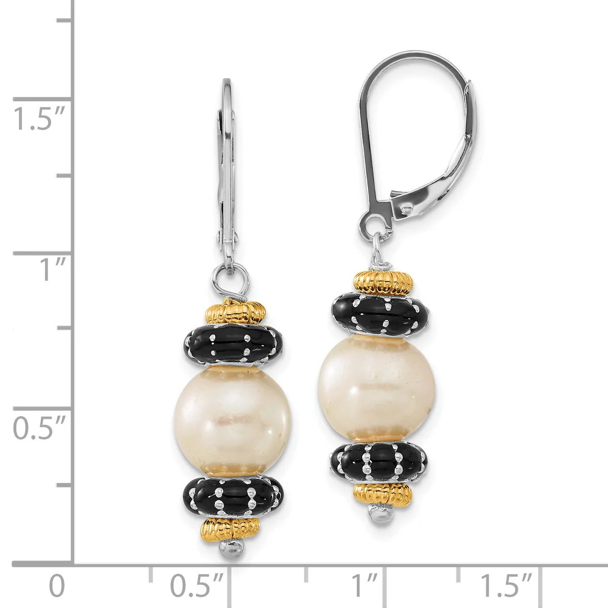 A pair of earrings with cream-colored pearl drops separated by black ridged beads and gold-toned spacers, suspended from leverback closures, shown against a measurement scale.