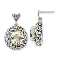 A pair of silver dangle earrings with ornate filigree bezels featuring round faceted pale yellow-green stones, displayed front and side view.