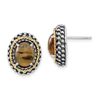 A pair of oval stud earrings with smoky quartz cabochon centers surrounded by twisted gold and textured silver bezels, shown from front and back views.