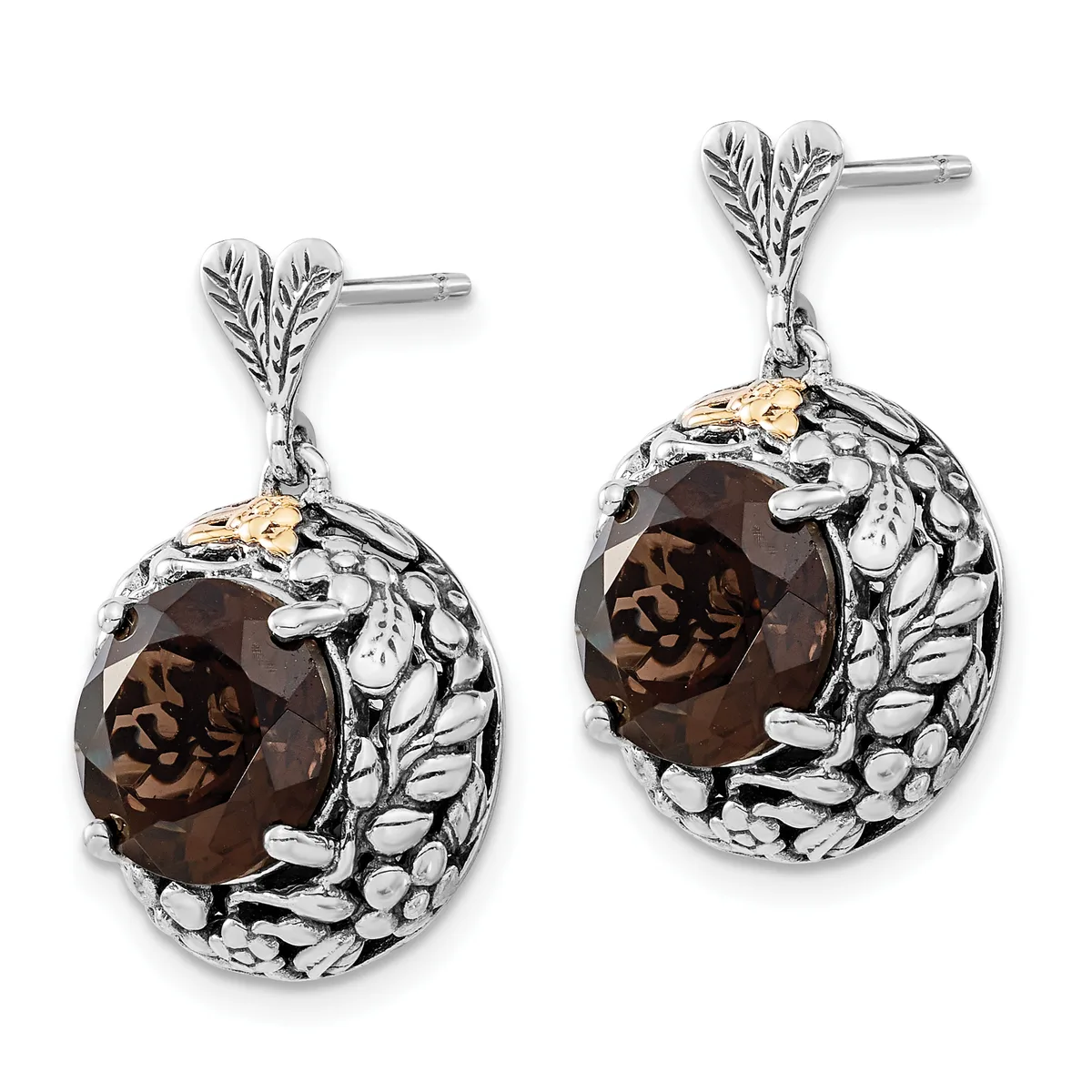 Pair of silver drop earrings with leaf-shaped posts, each featuring a faceted smoky quartz stone surrounded by a textured oval frame with gold accents.