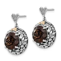 Pair of silver drop earrings with leaf-shaped posts, each featuring a faceted smoky quartz stone surrounded by a textured oval frame with gold accents.