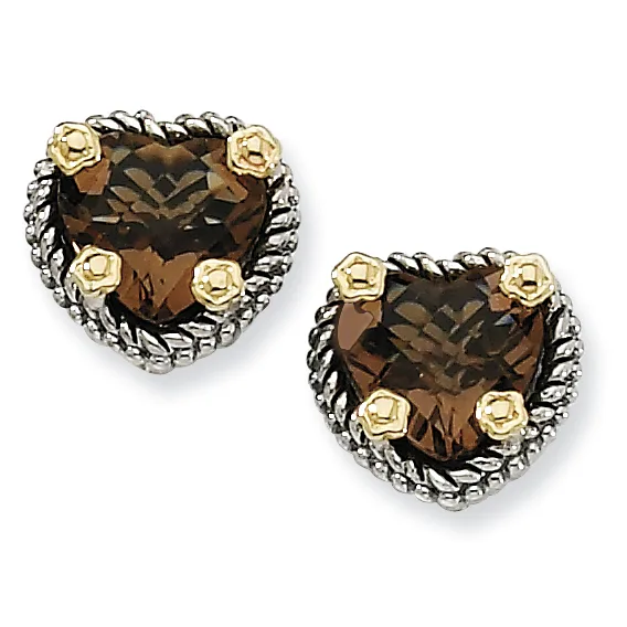 A pair of heart-shaped stud earrings with smoky quartz centers surrounded by twisted silver bezels and four gold-toned rose accents on each earring.