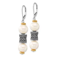 Pair of dangling earrings with silver lever backs, featuring two cream pearls separated by a textured silver cylindrical spacer with gold-tone accents on each ear.