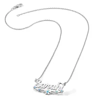 Silver chain necklace with a pendant spelling out a name in cursive script, decorated with small turquoise stones.