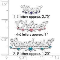 Three silver name charms with decorative hearts shown at actual size on a measurement ruler, ranging from 0.75 to 1.25 inches in width.