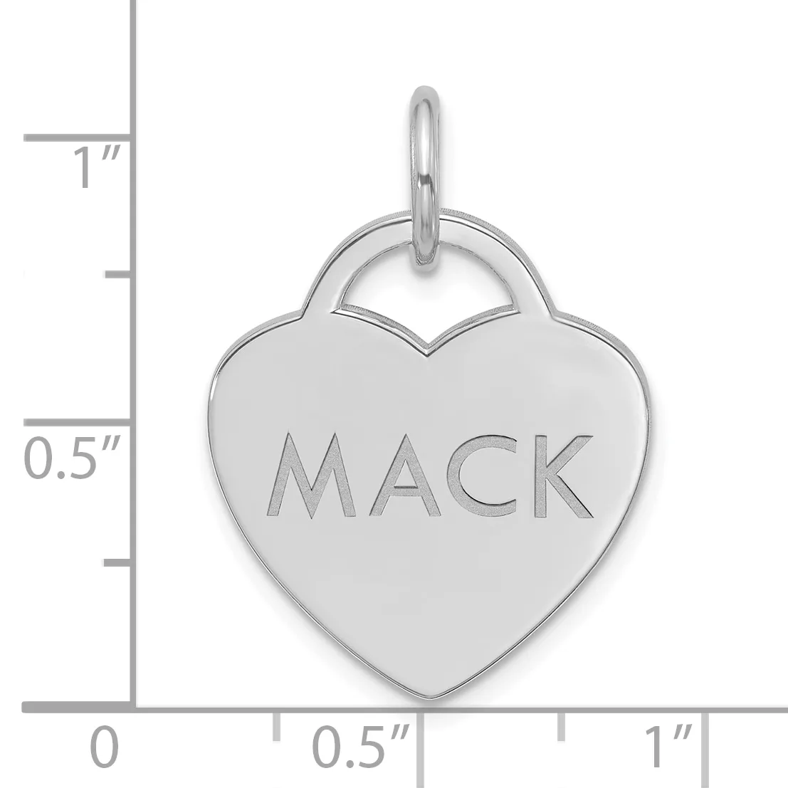 Silver heart-shaped pendant with the name "MACK" engraved on the front, shown next to a ruler indicating approximately one inch in height.